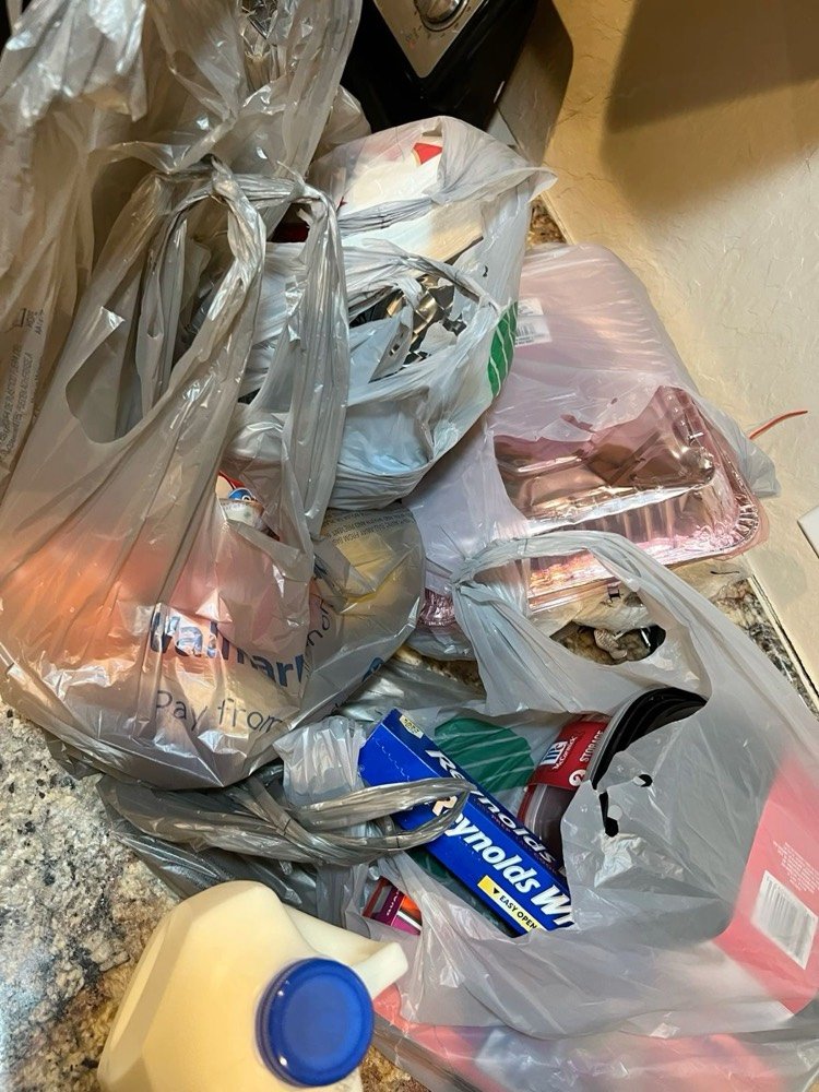 Grocery bags unpacked on a kitchen counter